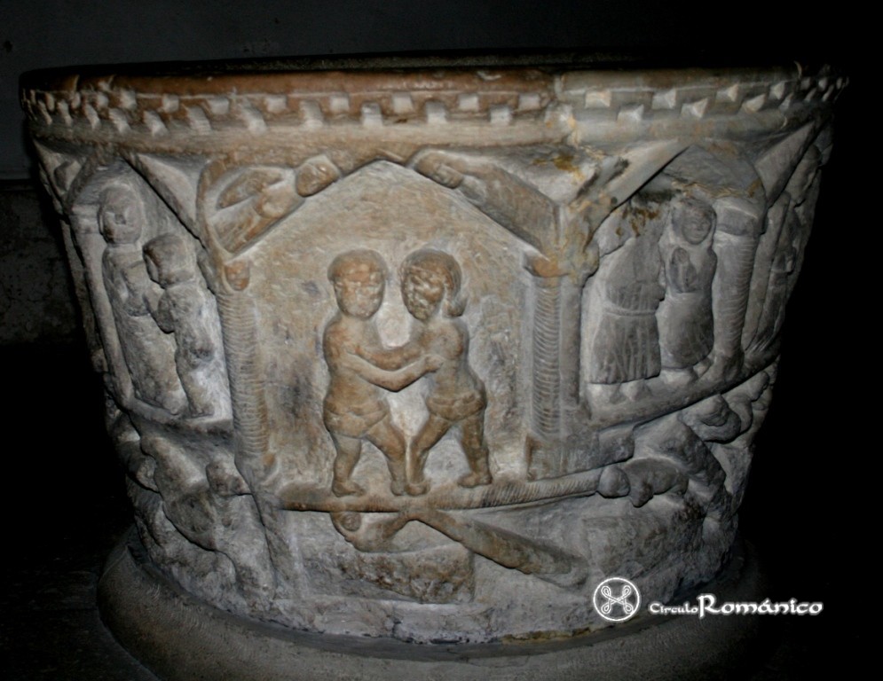 Guardo. San Juan Bautista. Pila bautismal: dos personajes abrazados